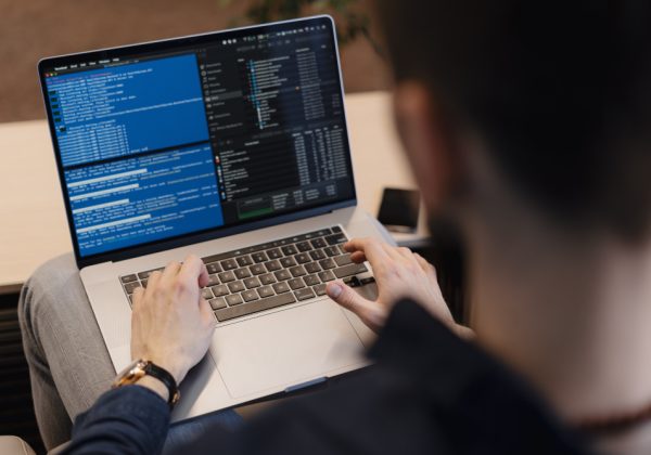 close-up-man-writing-code-laptop